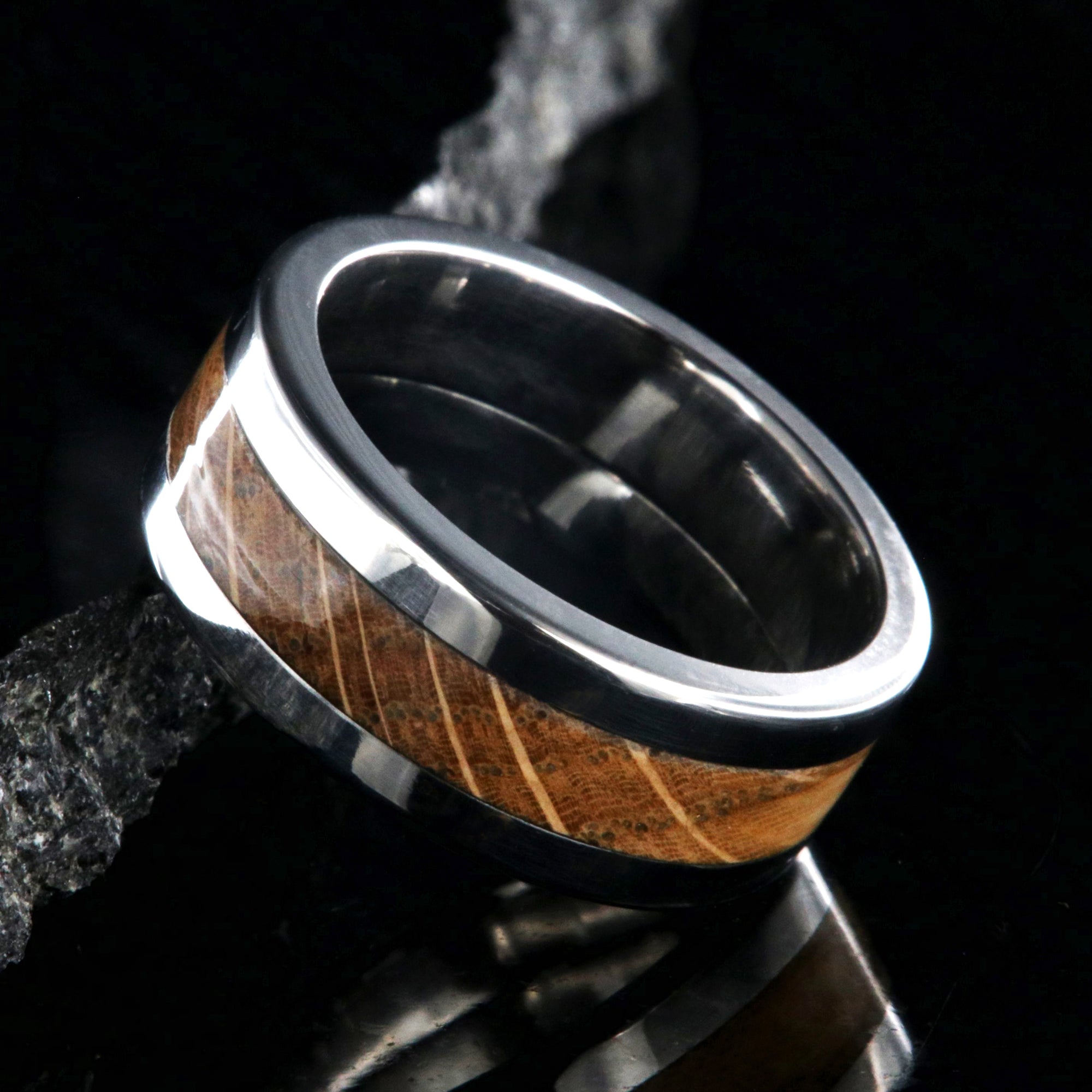 8mm wide wedding band with titanium edges and a whiskey barrel sleeve