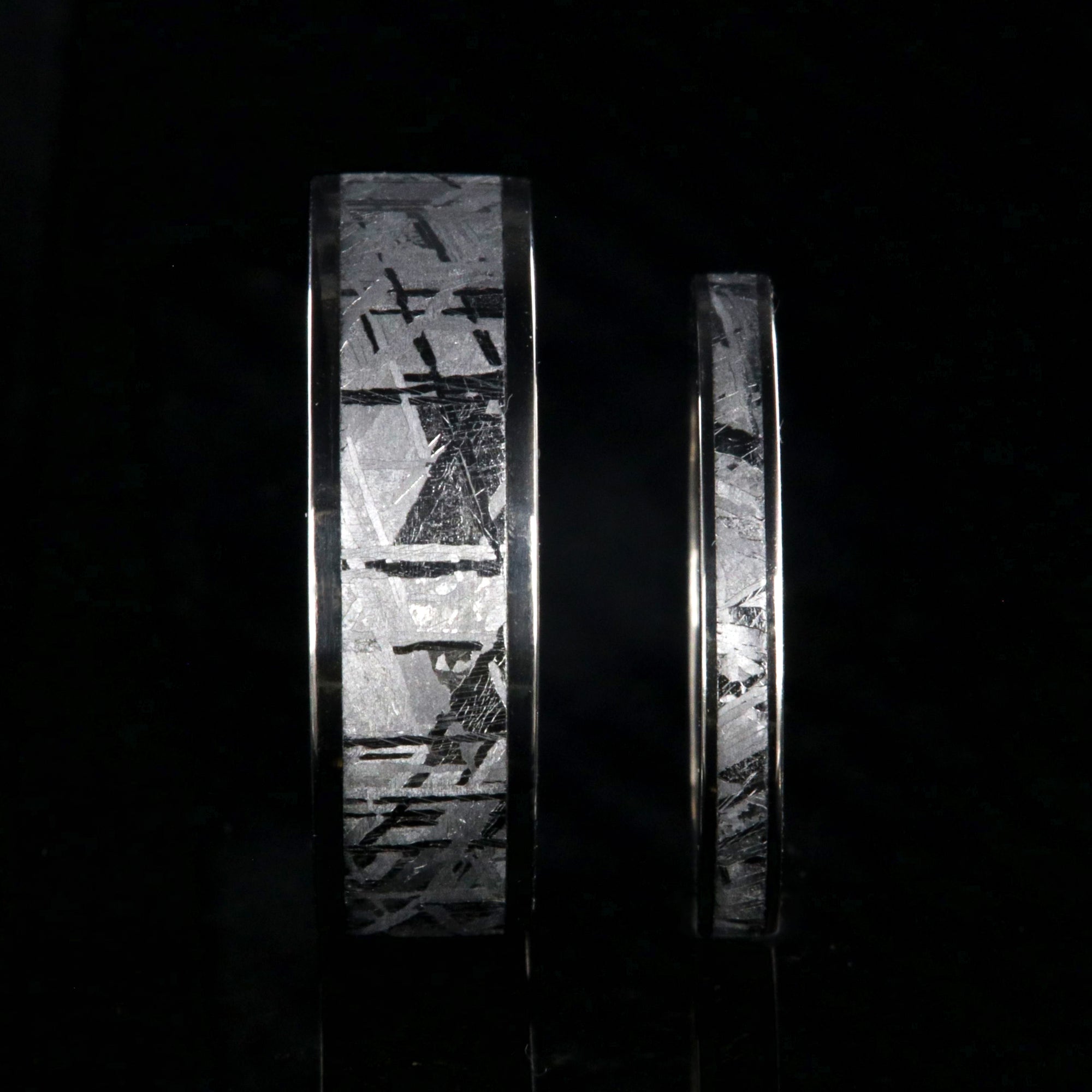 His and her matching wedding ring set with meteorite and titanium. 7mm wide and 3mm wide Gibeon meteorite rings