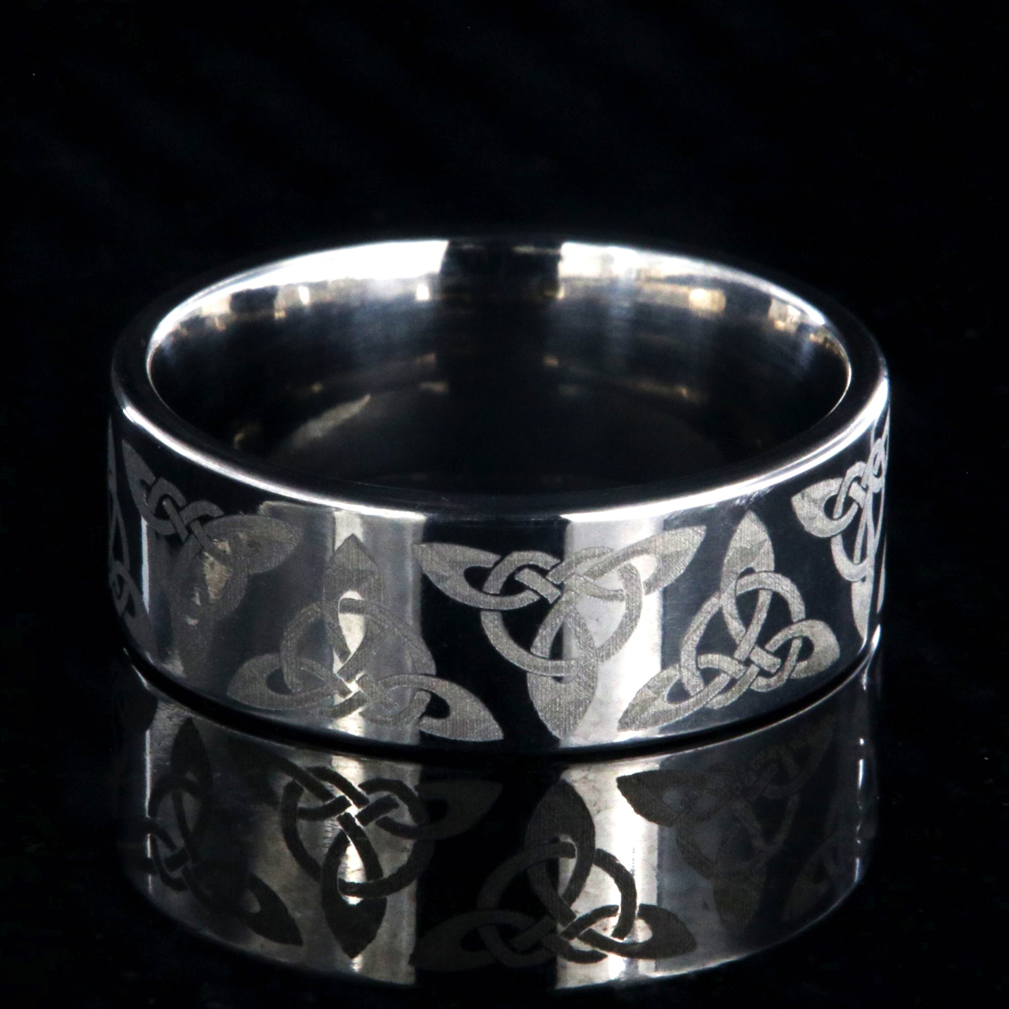 8mm wide titanium ring with a Celtic trinity know design and a flat profile