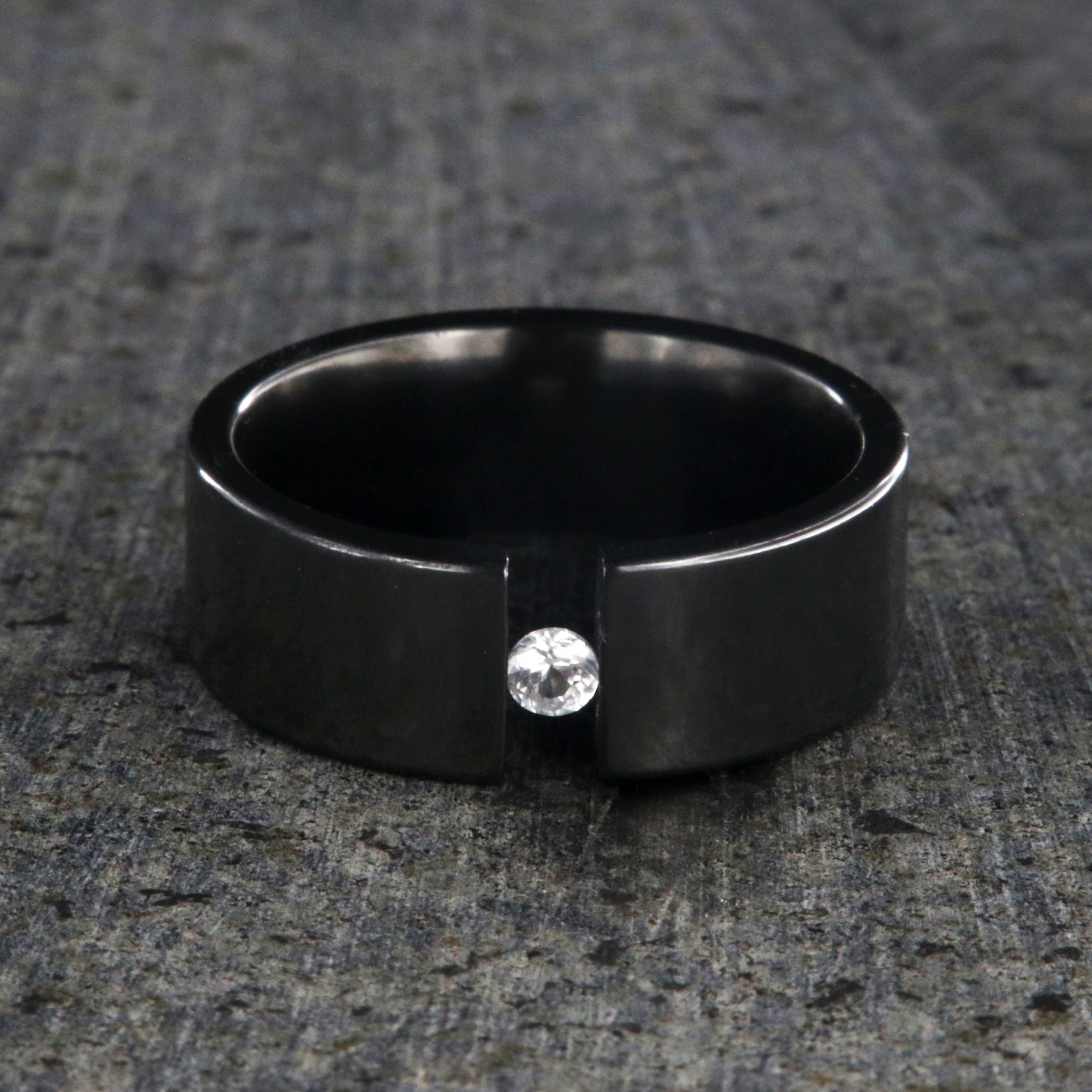 8mm wide black zirconium tension set ring with 3mm round gemstone