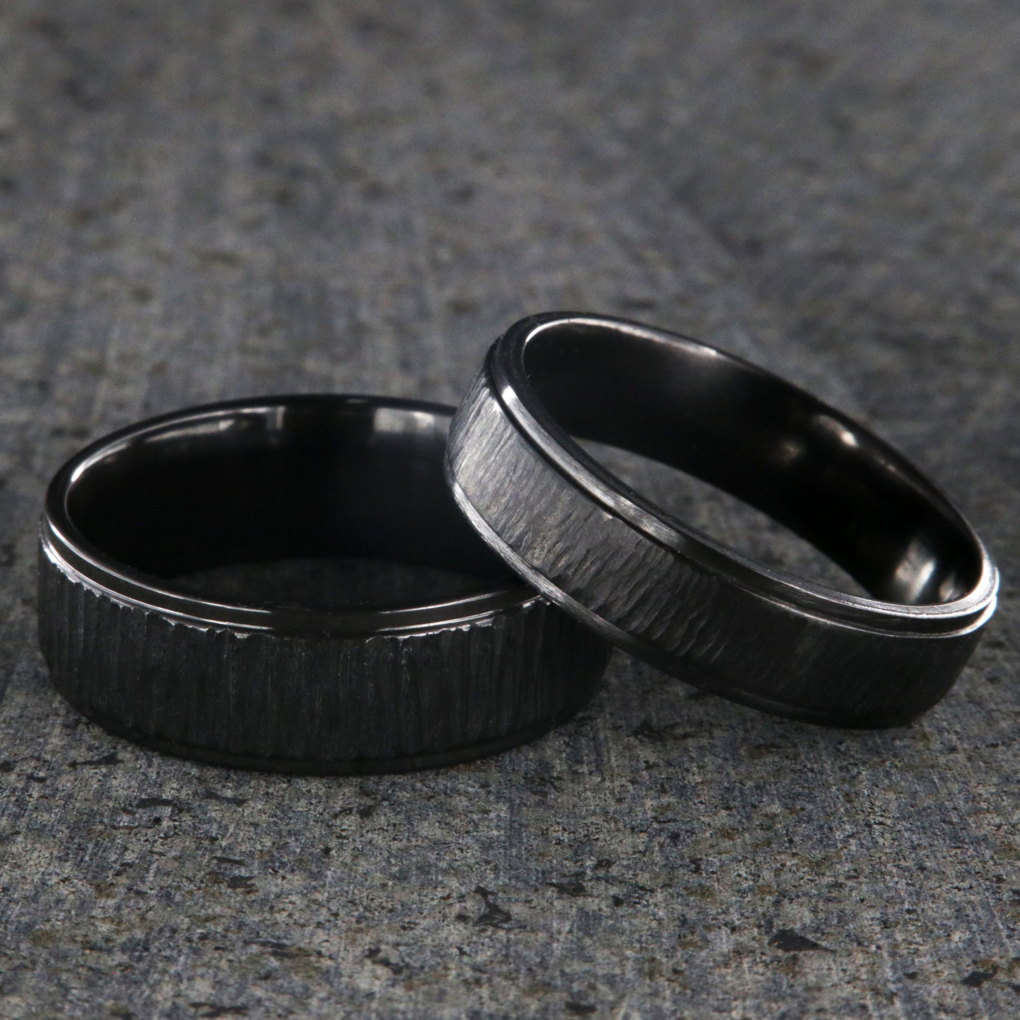 8mm and 6mm wide matching black zirconium wedding ring set with a raised center and tree bark finish