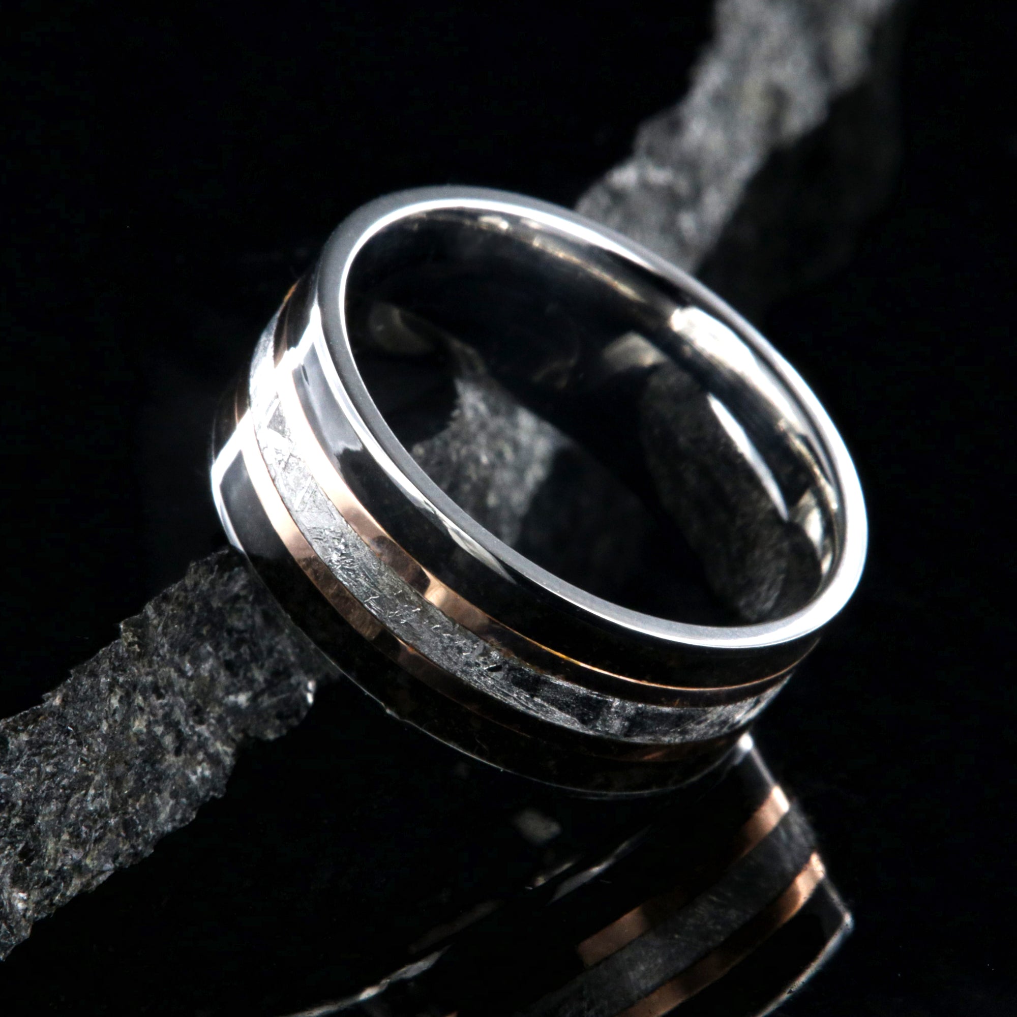 9mm wide ring with meteorite center, dual rose gold inlays, and dinosaur bone edges