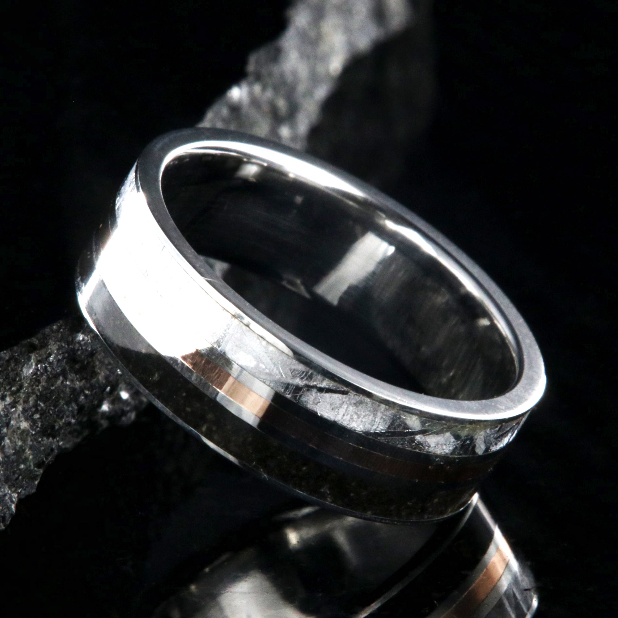 7mm wide wedding band with a center rose gold inlay and dinosaur fossil edge and meteorite edge