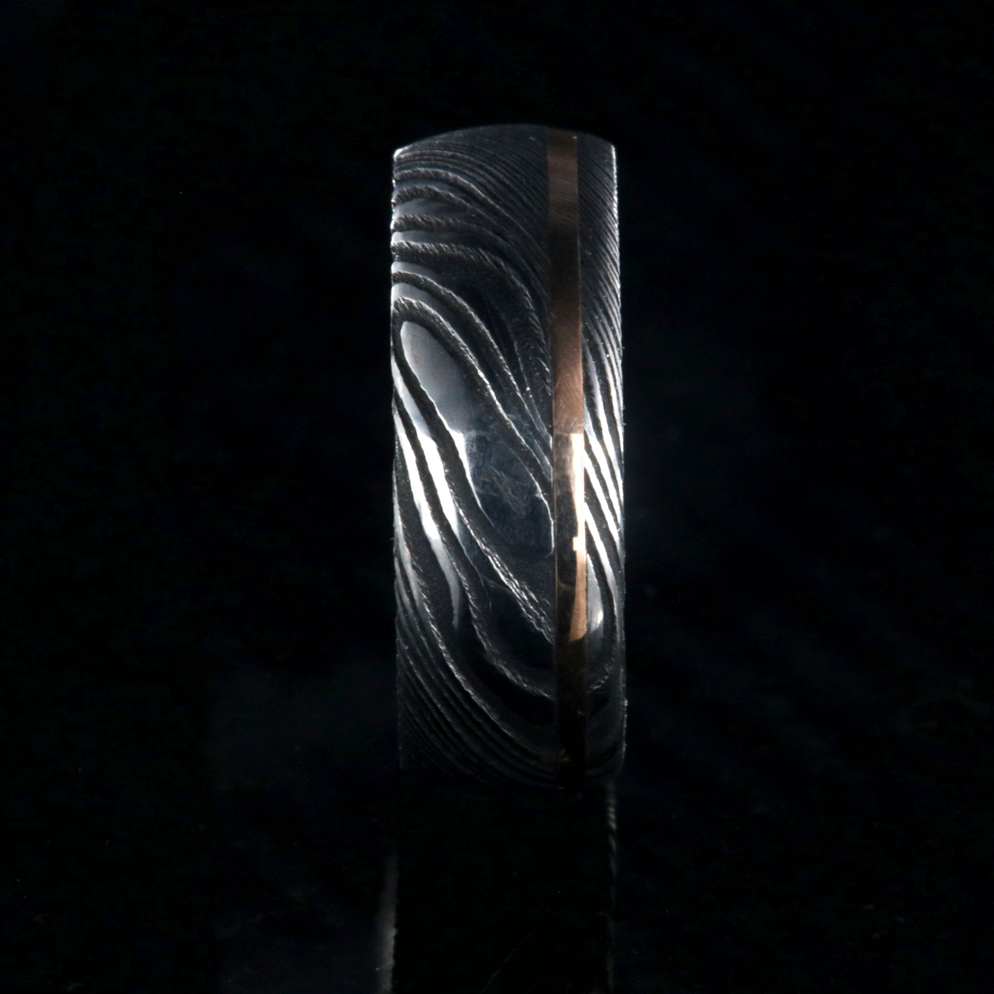 8mm wide Damascus steel ring with rose gold inlay