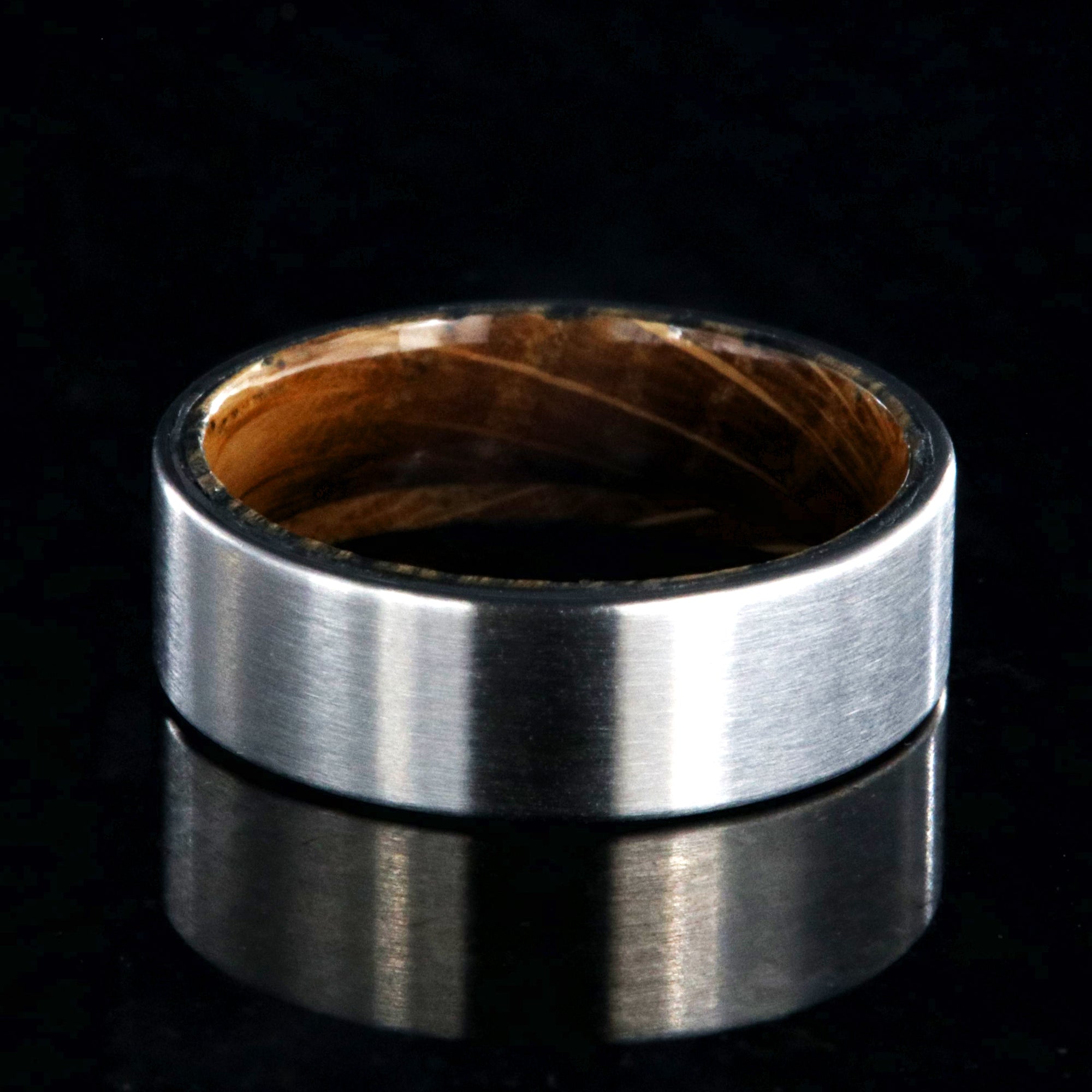 7mm wide titanium wedding band with a whiskey barrel sleeve and flat profile