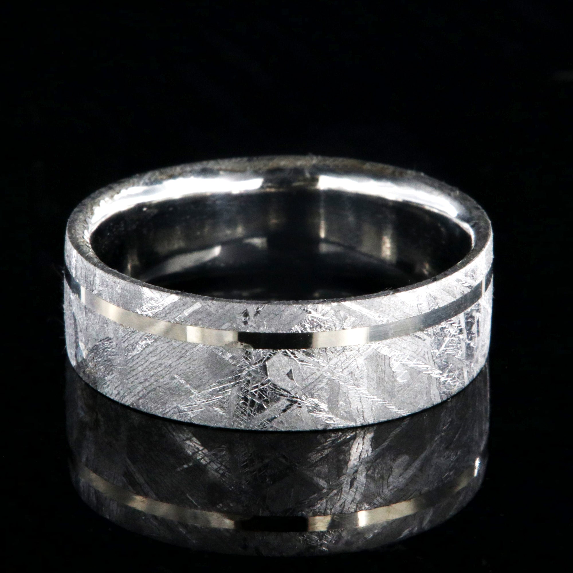 8mm wide men's meteorite wedding band with an off-centered white gold inlay, polished cobalt sleeve, and flat profile