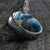 6mm wide black zirconium wedding band with a distressed finish and a blue, white, and brown DiamondCast sleeve