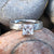 4mm wide women's meteorite engagement ring with a princess cut moissanite stone