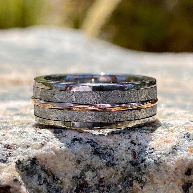 7mm wide men's meteorite ring with a twisted center rose gold inlay with titanium edges and sleeve
