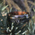 8mm wide black Damascus steel ring with dual inlay of rose gold and yellow gold with an Arizona ironwood sleeve