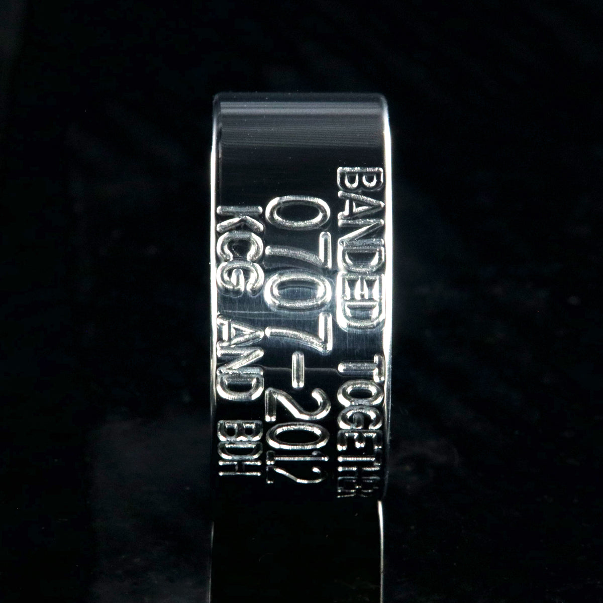 10mm wide titanium duck band wedding ring with polished finish, flat profile, and 3 lines of personalized text