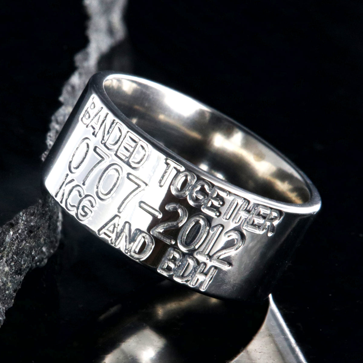 10mm wide titanium duck band wedding ring with polished finish, flat profile, and 3 lines of personalized text