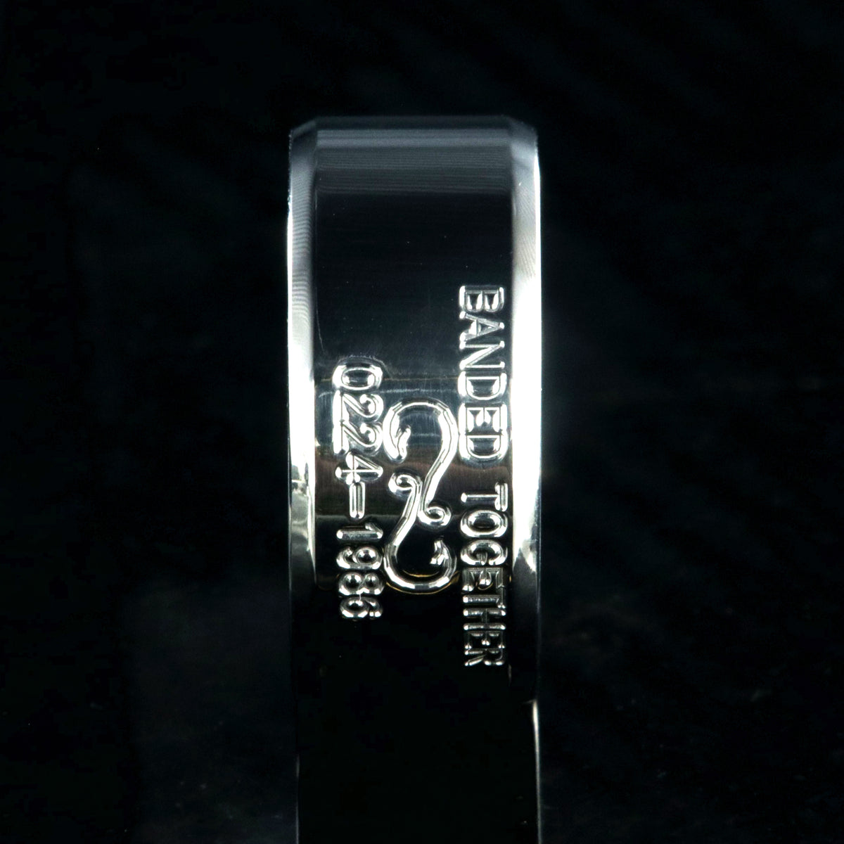 10mm wide titanium duck band with beveled edges and two lines of personalized text above and below an infinity hook design