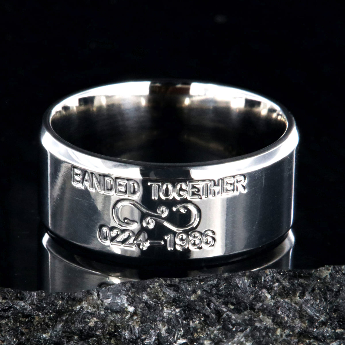 10mm wide titanium duck band with beveled edges and two lines of personalized text above and below an infinity hook design