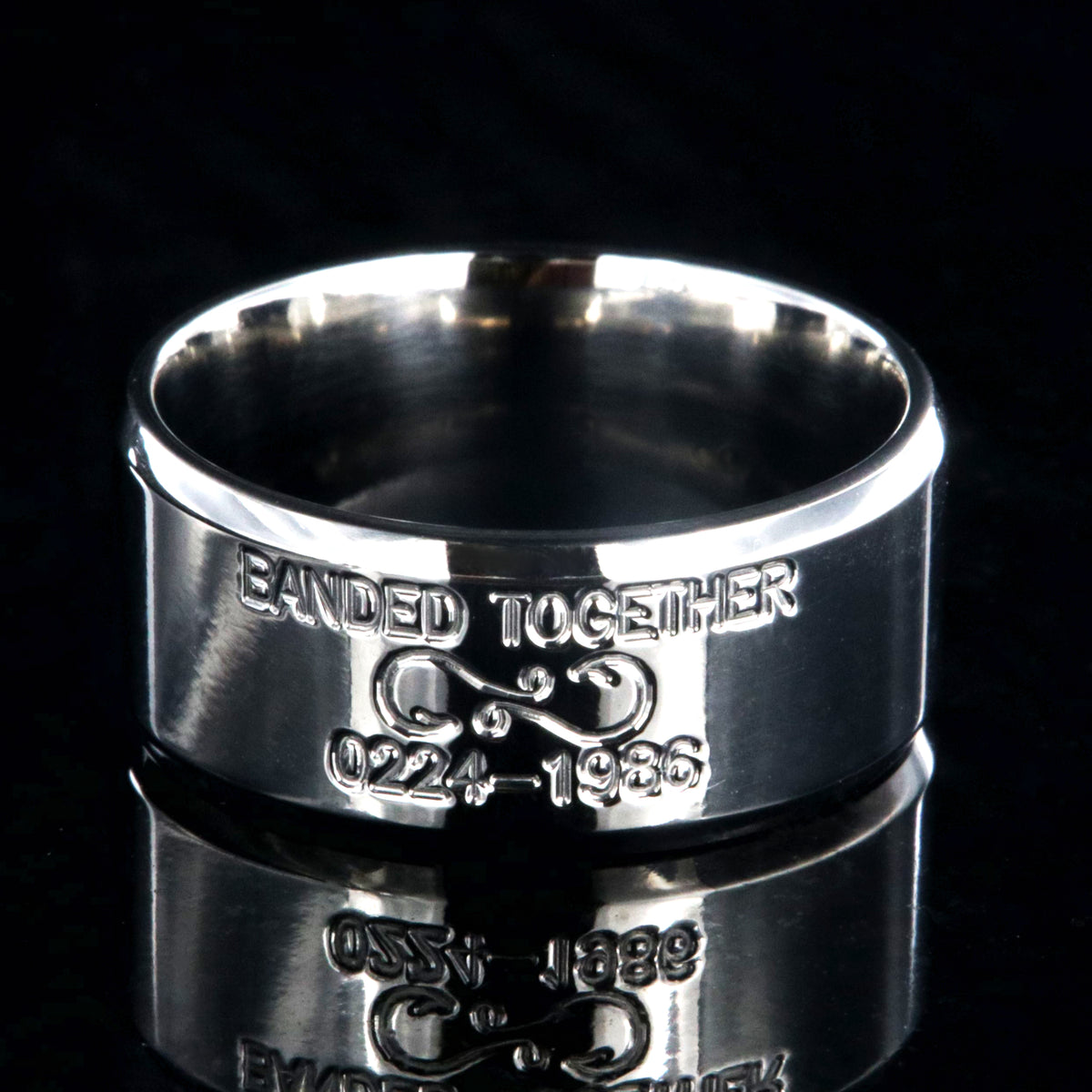 10mm wide titanium duck band with beveled edges and two lines of personalized text above and below an infinity hook design