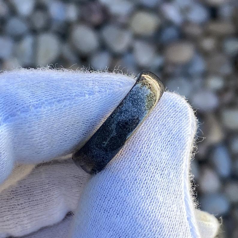 6mm wide men&#39;s wedding band, black stardust outside with solid yellow gold sleeve held by a white glove