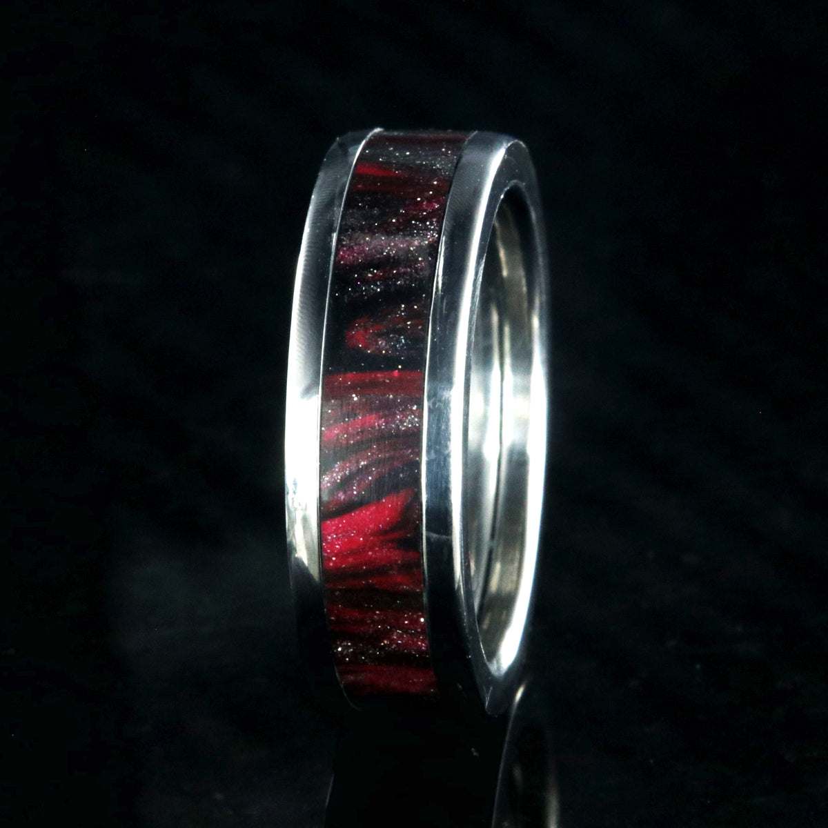 6mm wide titanium ring with pink and black swirl patterned inlay