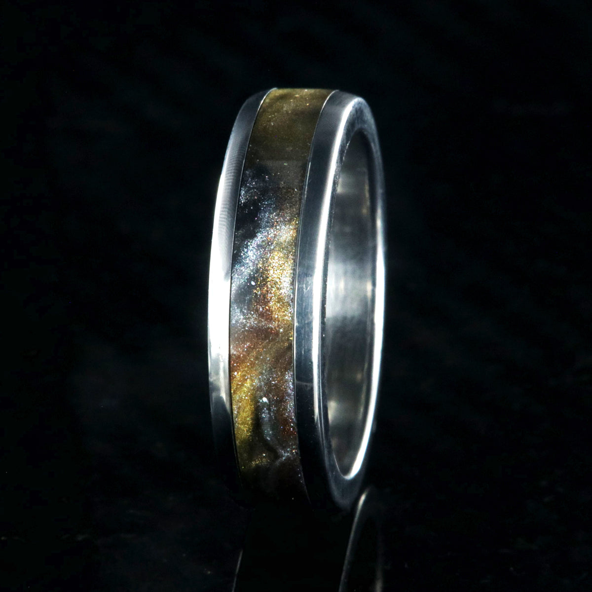 6mm wide titanium ring with a gold, black, and silver inlay