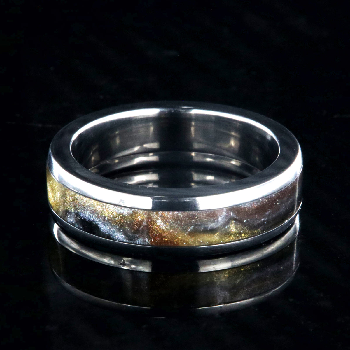 6mm wide titanium ring with a gold, black, and silver inlay
