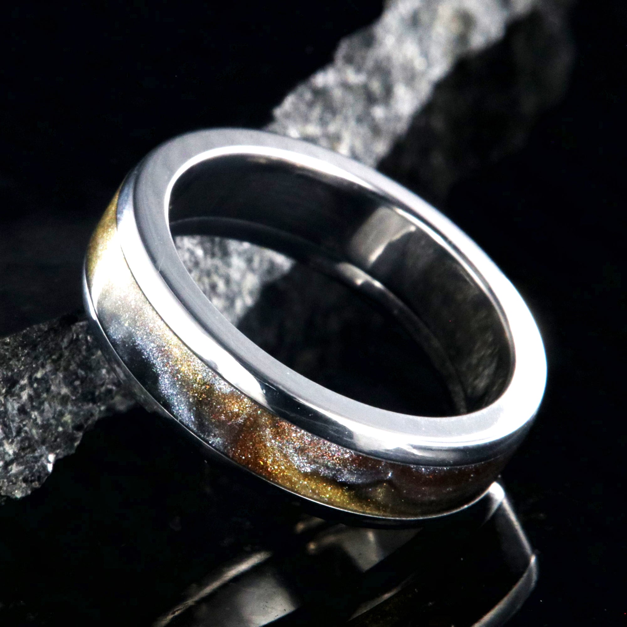 6mm wide titanium ring with a gold, black, and silver inlay