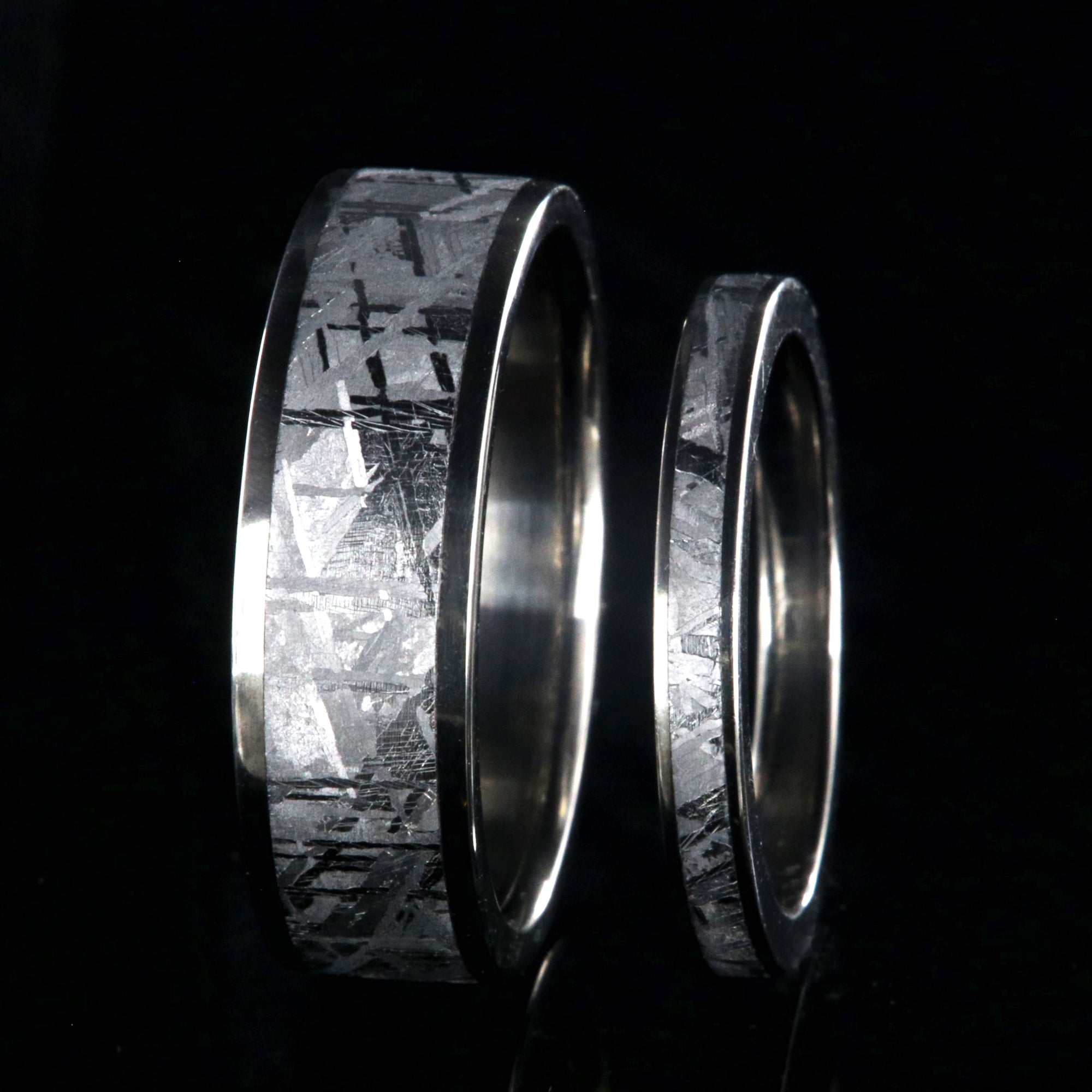 His and her matching wedding ring set with meteorite and titanium. 7mm wide and 3mm wide Gibeon meteorite rings