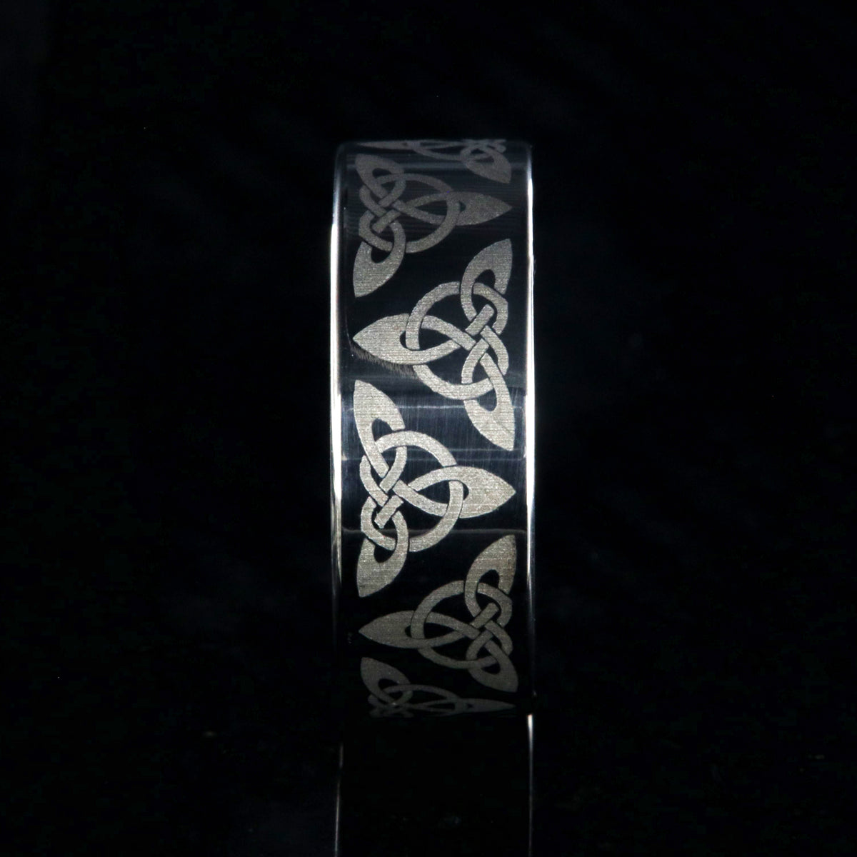 8mm wide titanium ring with a Celtic trinity know design and a flat profile