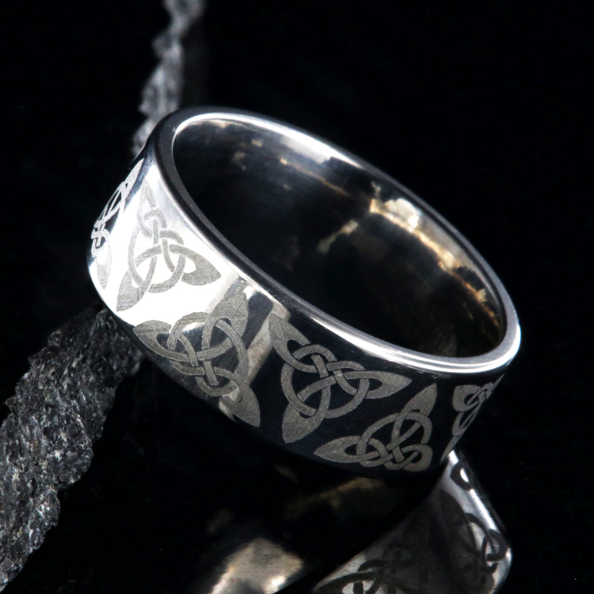 8mm wide titanium ring with a Celtic trinity know design and a flat profile
