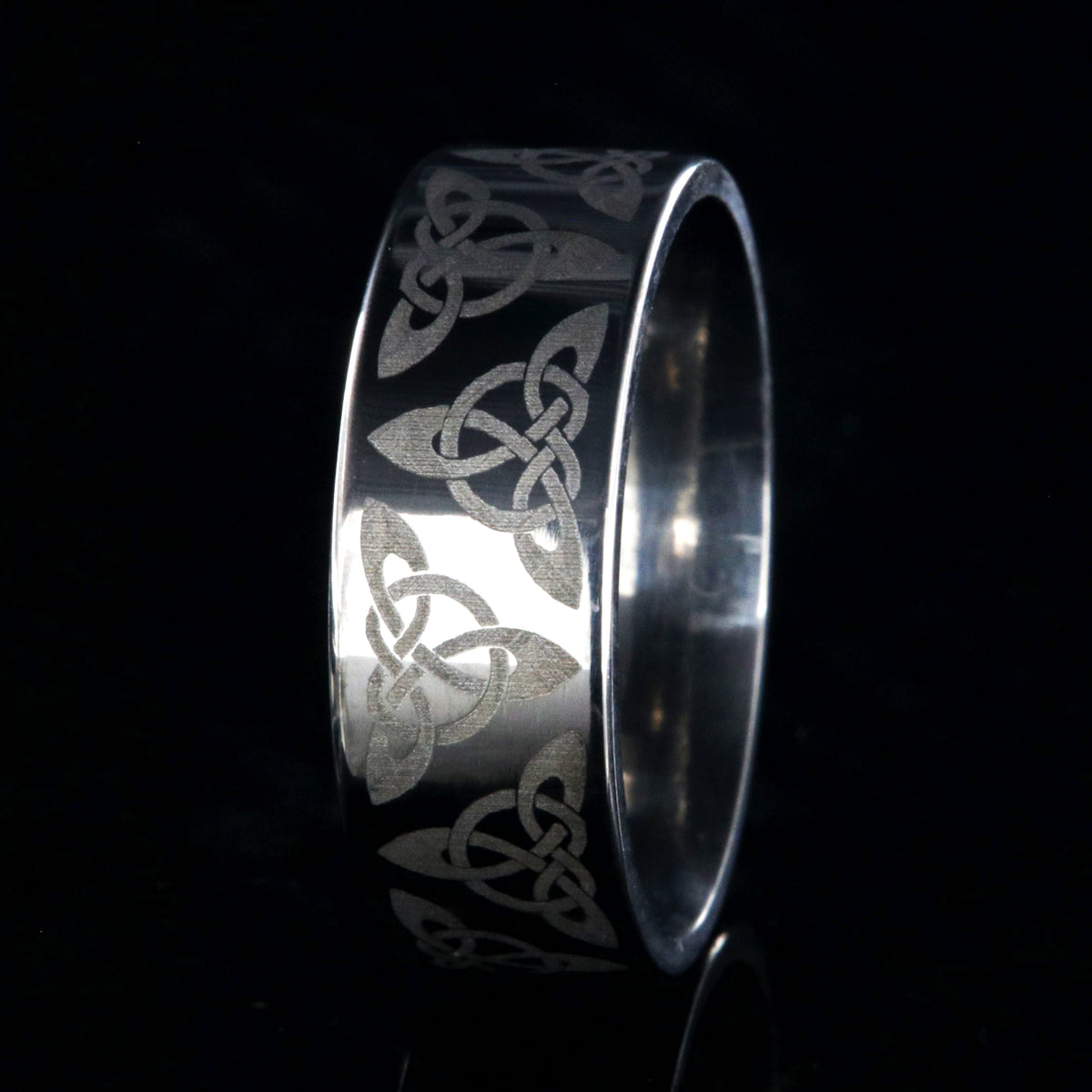 8mm wide titanium ring with a Celtic trinity know design and a flat profile