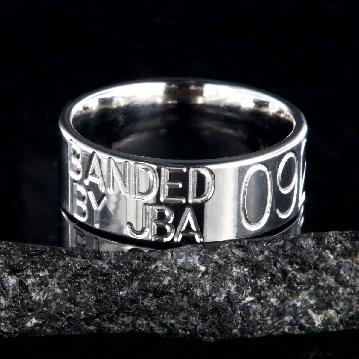 8mm wide titanium duck band with two lines of text adjacent to a large line of numbers, flat profile