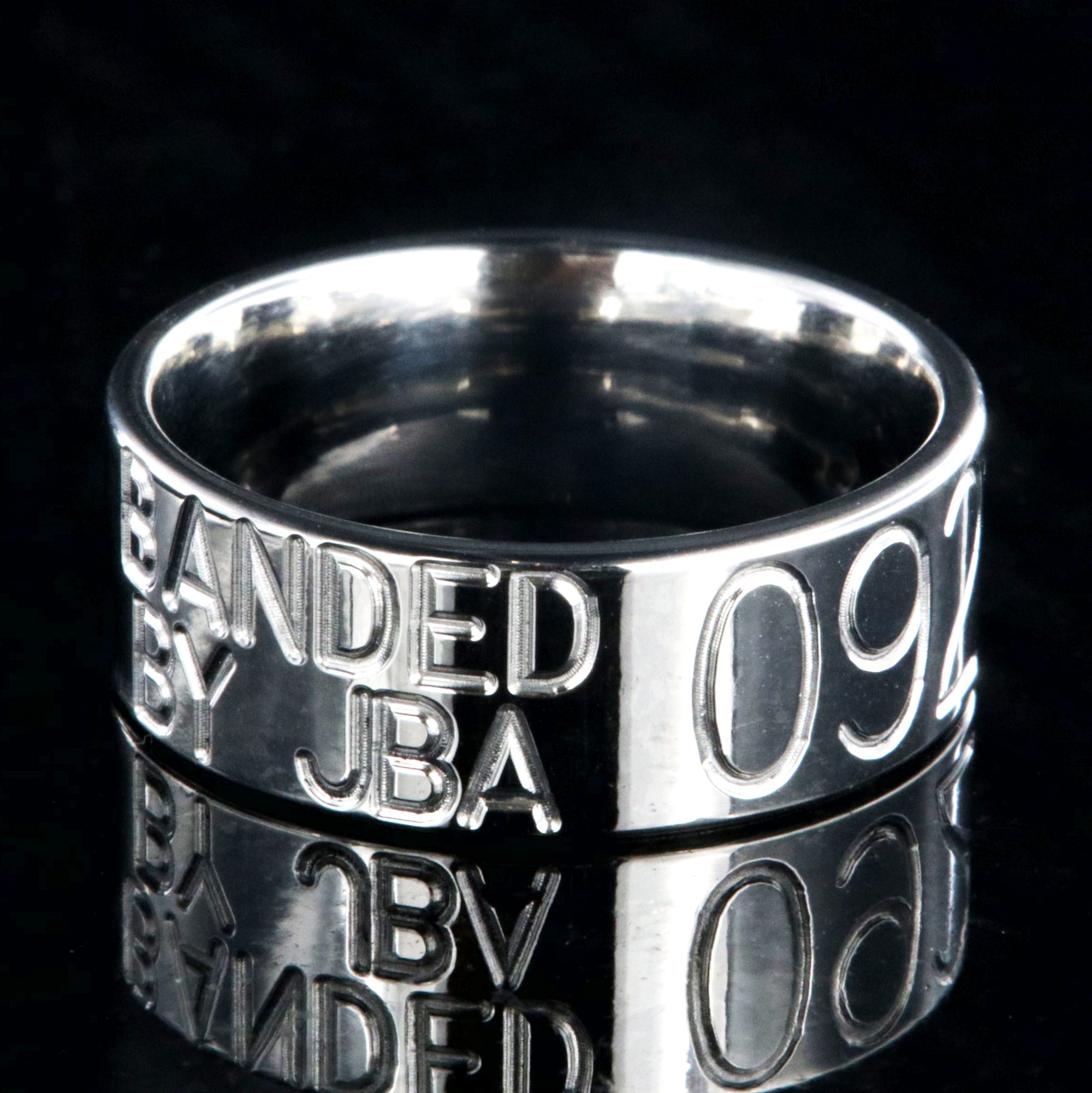 8mm wide titanium duck band with two lines of text adjacent to a large line of numbers, flat profile