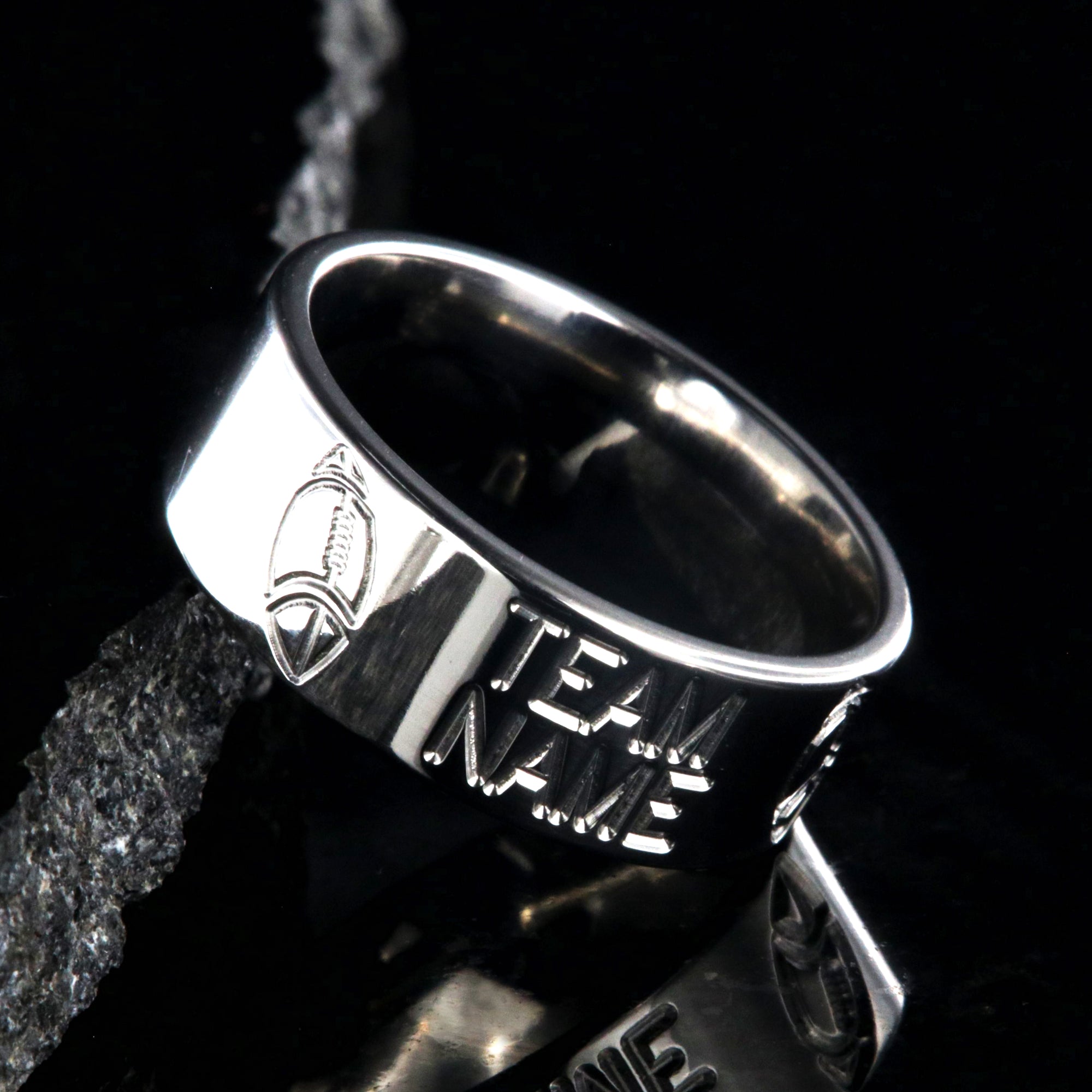 8mm wide titanium football ring with milled footballs and a custom team name