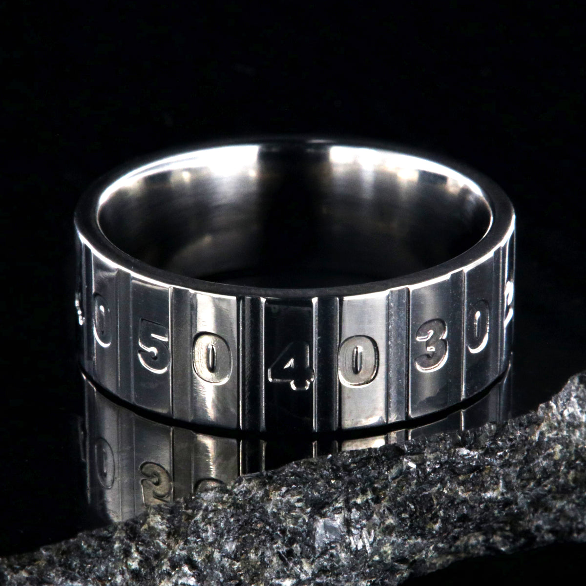 8mm wide titanium football ring with a yardage design
