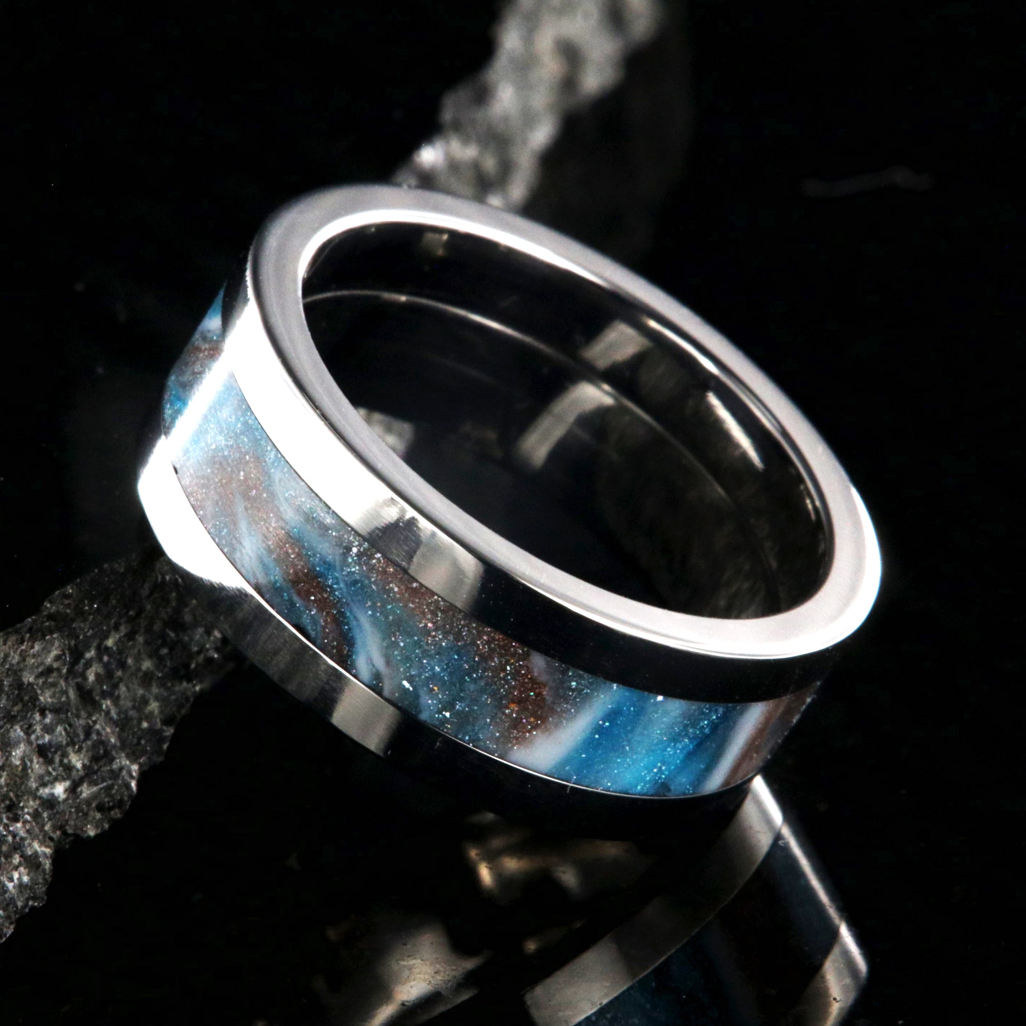 8mm wide titanium ring with blue, white, and brown glittering inlay
