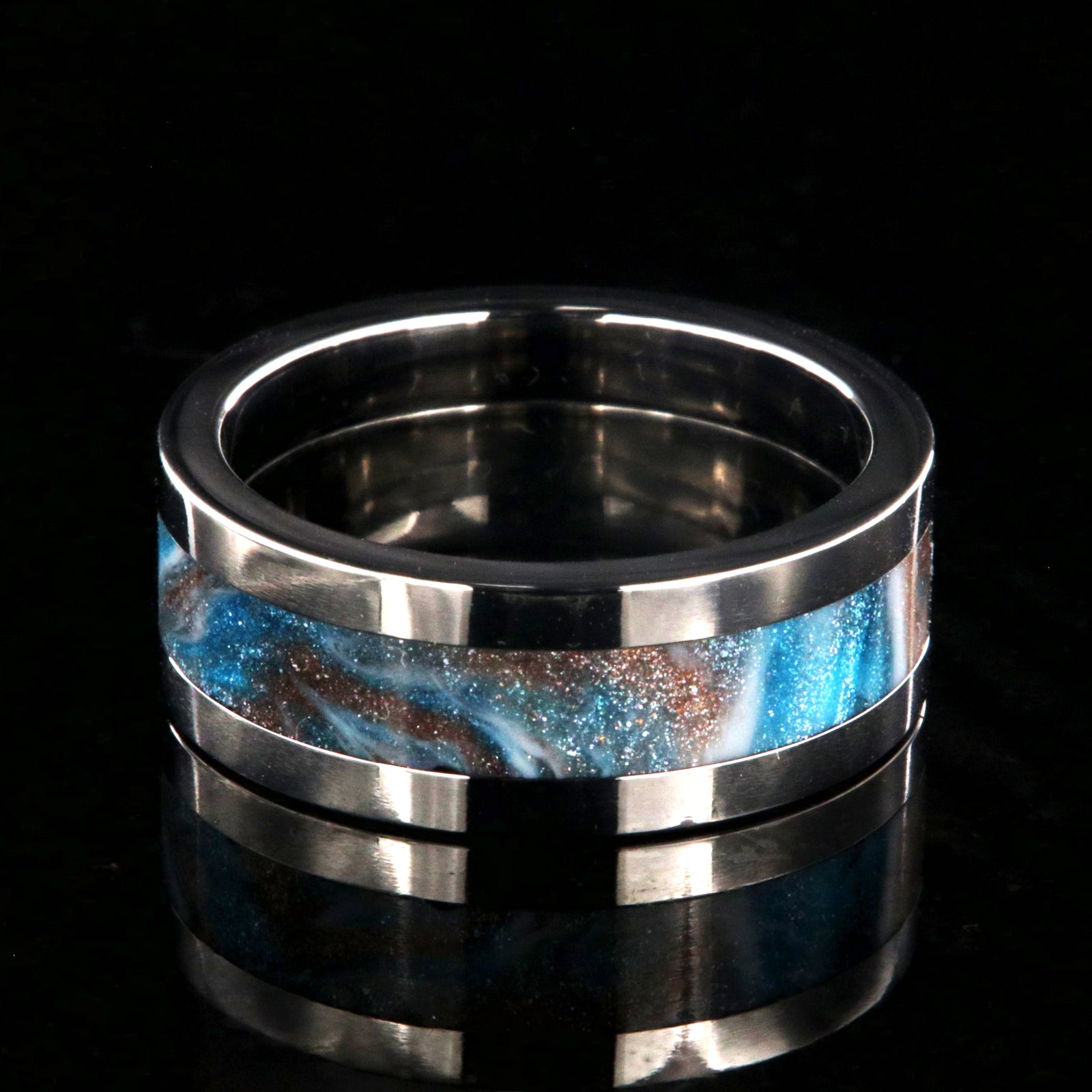 8mm wide titanium ring with blue, white, and brown glittering inlay