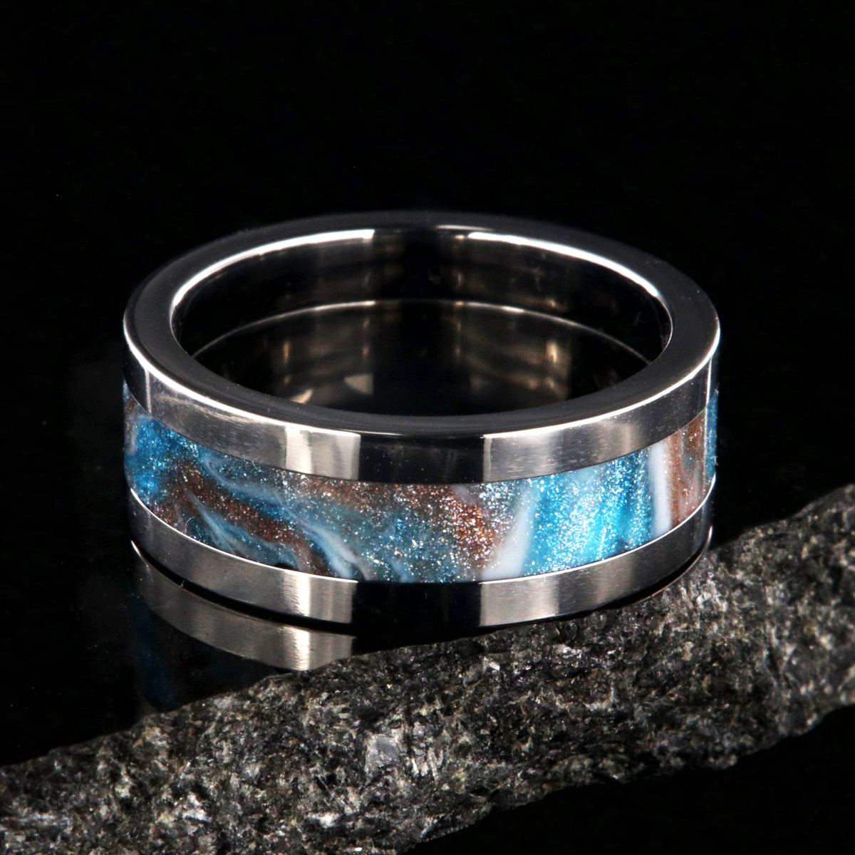 8mm wide titanium ring with blue, white, and brown glittering inlay