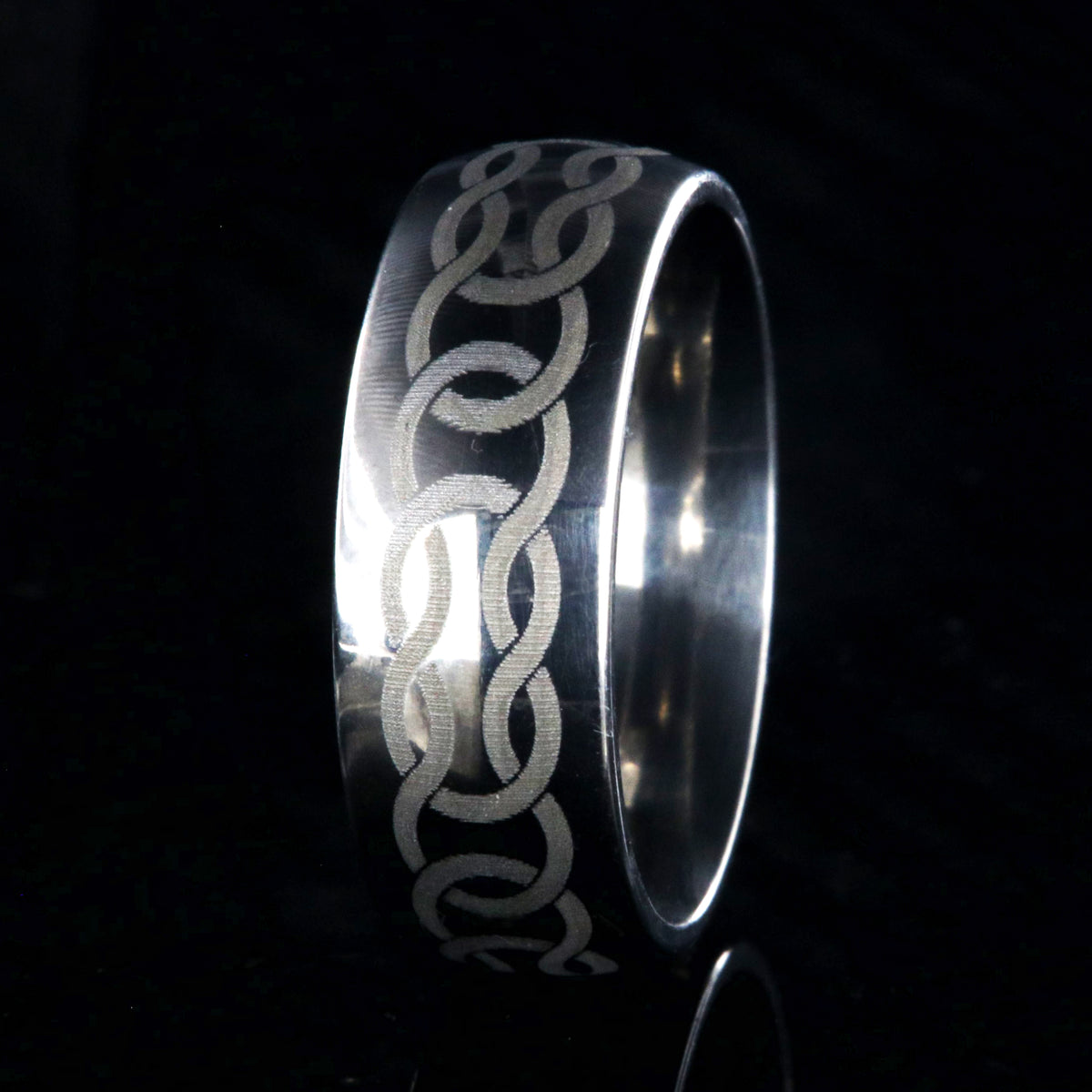 8mm wide titanium ring with Celtic knot design and rounded profile