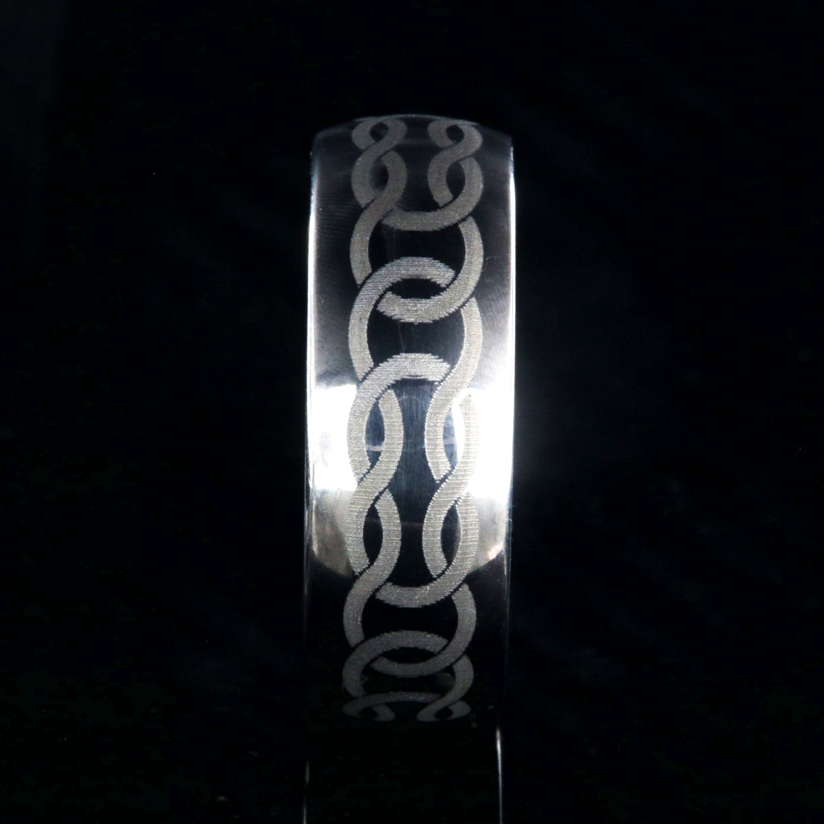 8mm wide titanium ring with Celtic knot design and rounded profile