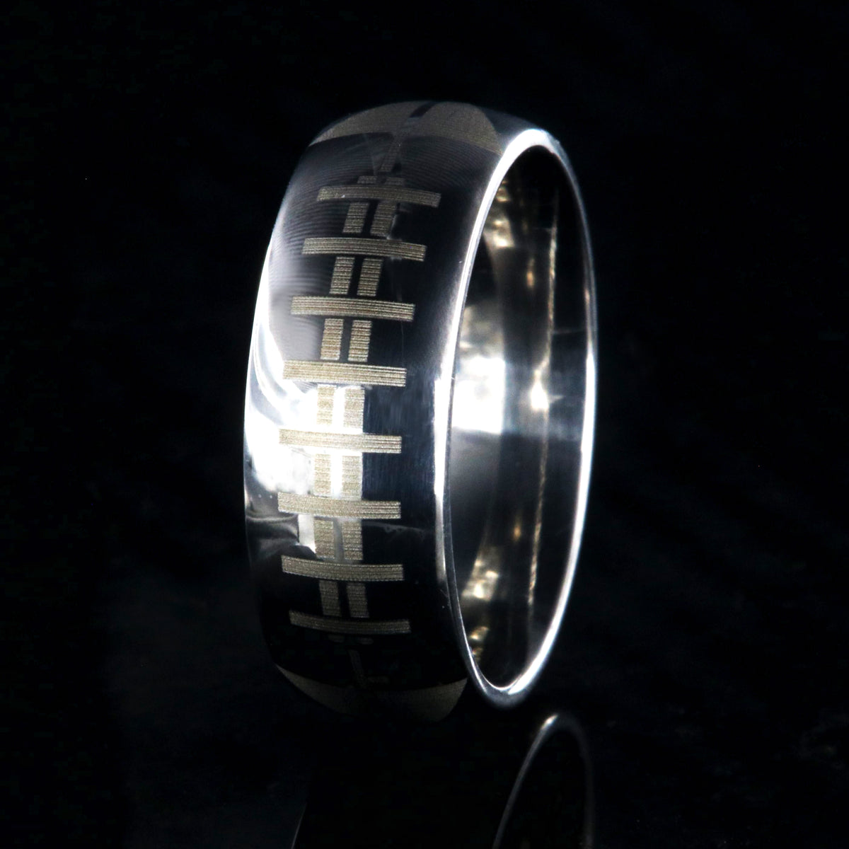 8mm wide titanium football ring with layered football design 