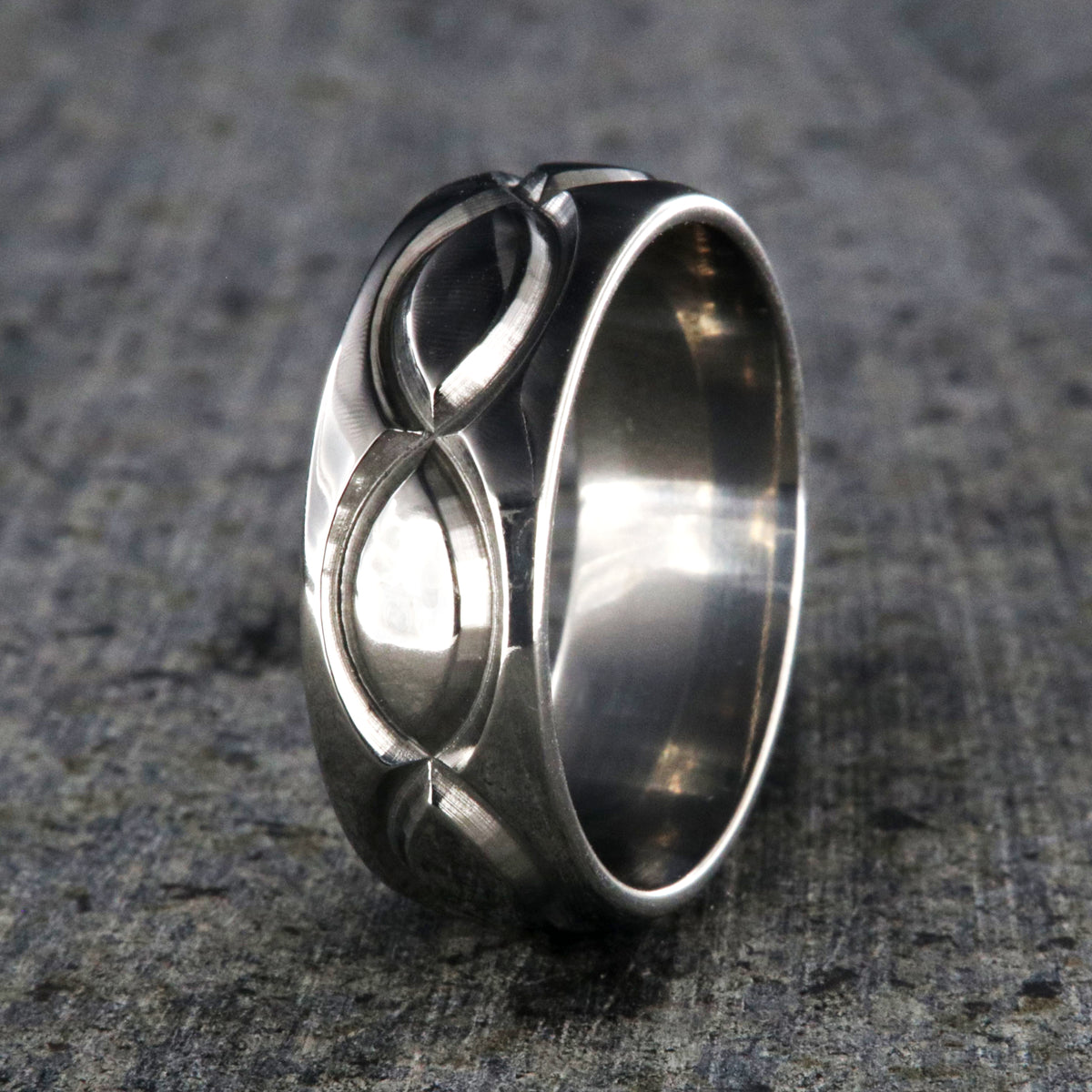 8mm wide titanium wedding band with a milled infinity design and rounded profile