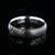 6mm wide black Damascus steel wedding band with a single vertical rose gold inlay
