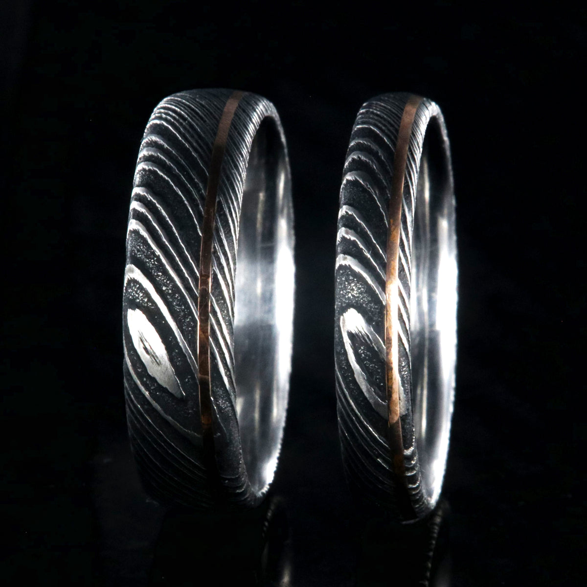 6mm and 4mm wide matching Damascus steel wedding bands with a ultra-narrow rose gold inlay