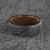Flat profiled 8mm wide black Damascus steel ring with Jack Daniel's whiskey barrel sleeve