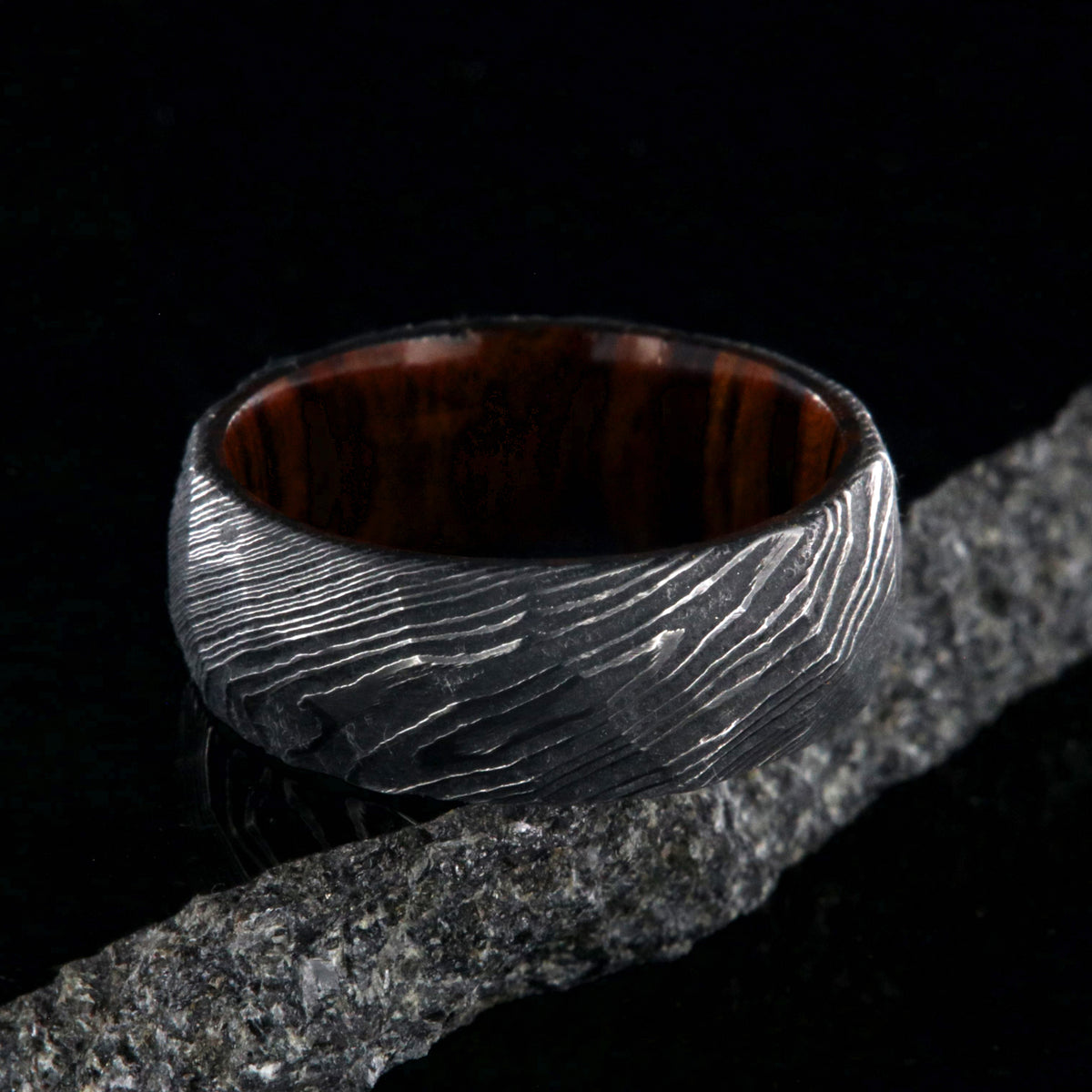 8mm wide black Damascus steel men&#39;s wedding band with an Arizona ironwood sleeve and hammered band finish