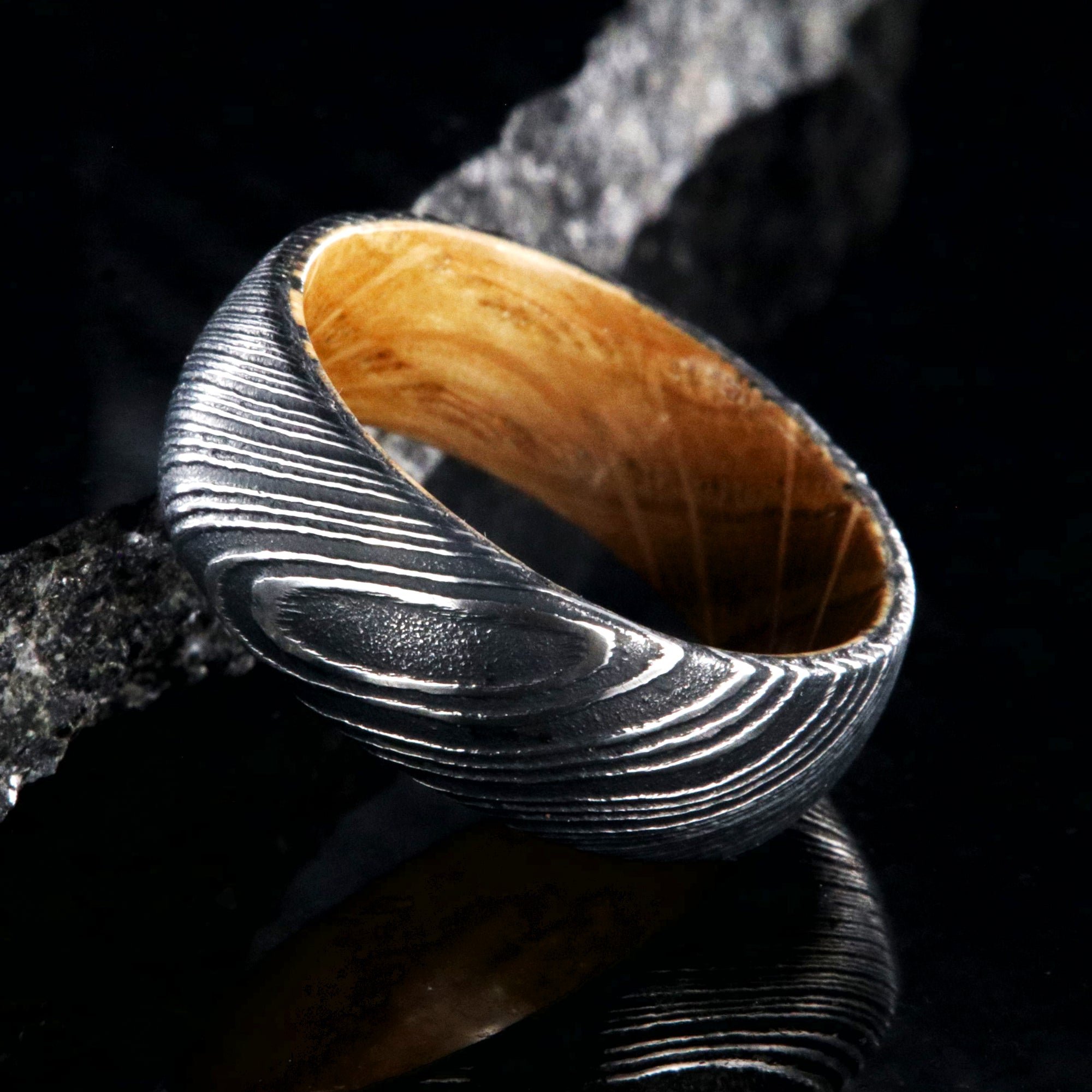 8mm wide black Damascus steel ring with Jack Daniel's whiskey barrel sleeve and rounded profile