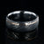 8mm wide black Damascus steel wedding band with an ultra-thin rose gold inlay