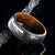 8mm wide Jack Daniel's whiskey barrel sleeve wedding ring set in black Damascus steel with a thin off-centered gold inlay