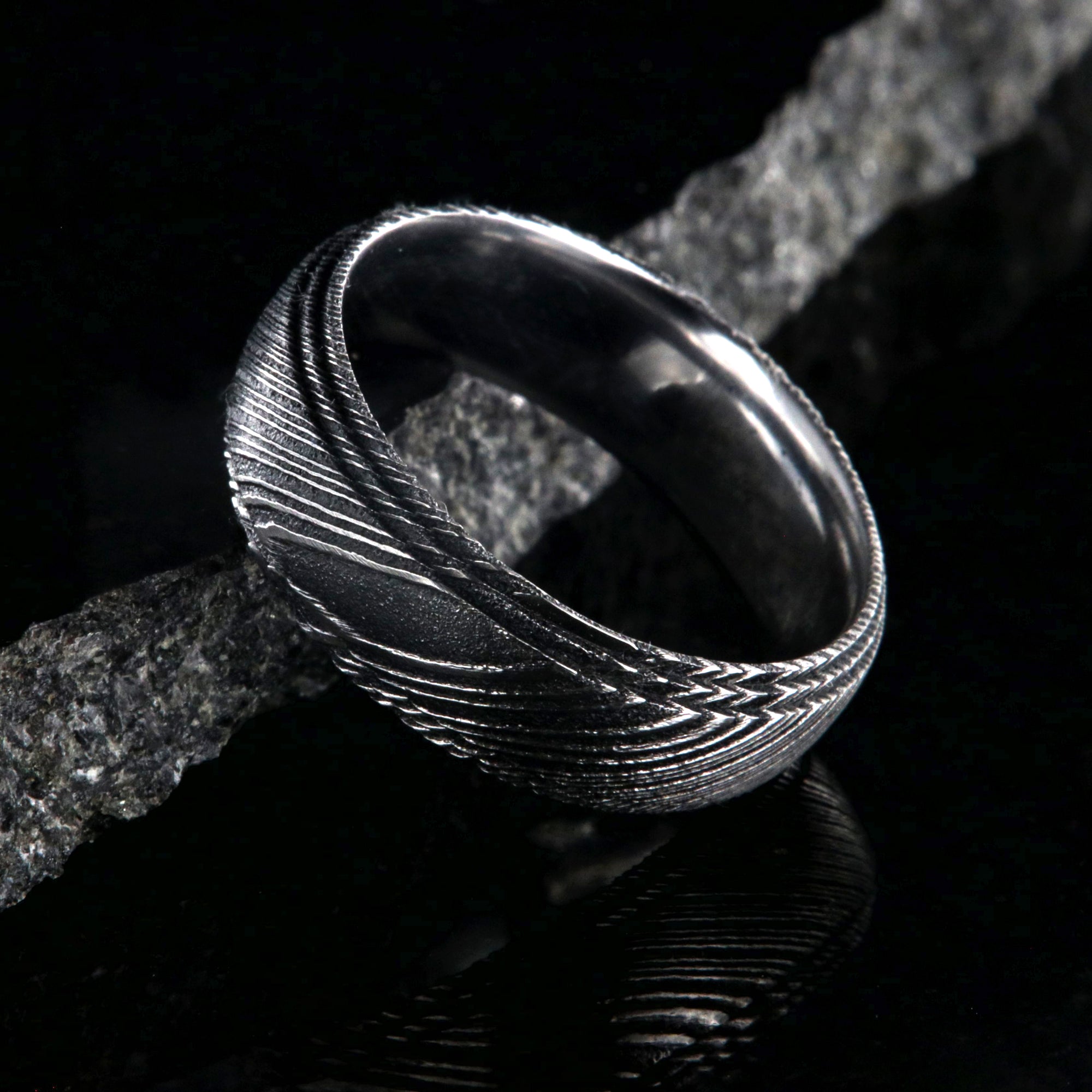 8mm wide black Damascus steel ring for men with a polish inside and a 2 step grooved edges