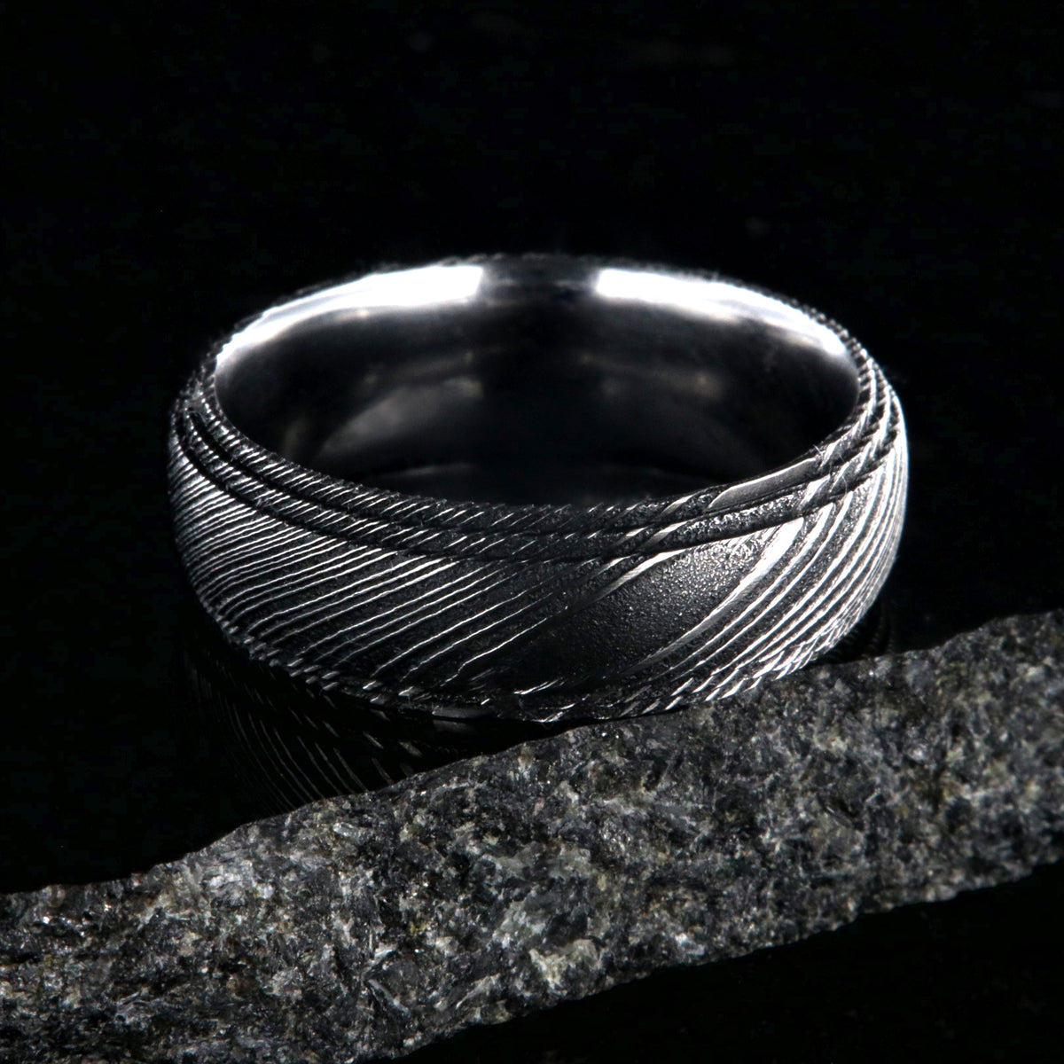 8mm wide black Damascus steel ring for men with a polish inside and a 2 step grooved edges