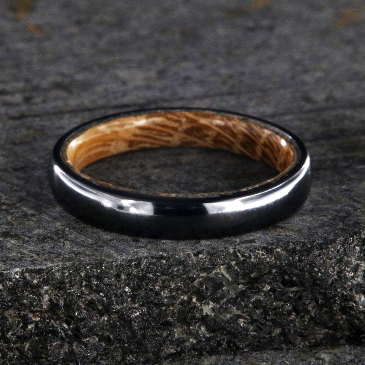 4mm wide black titanium wedding band with a rounded profile, polish finish, and whiskey barrel sleeve