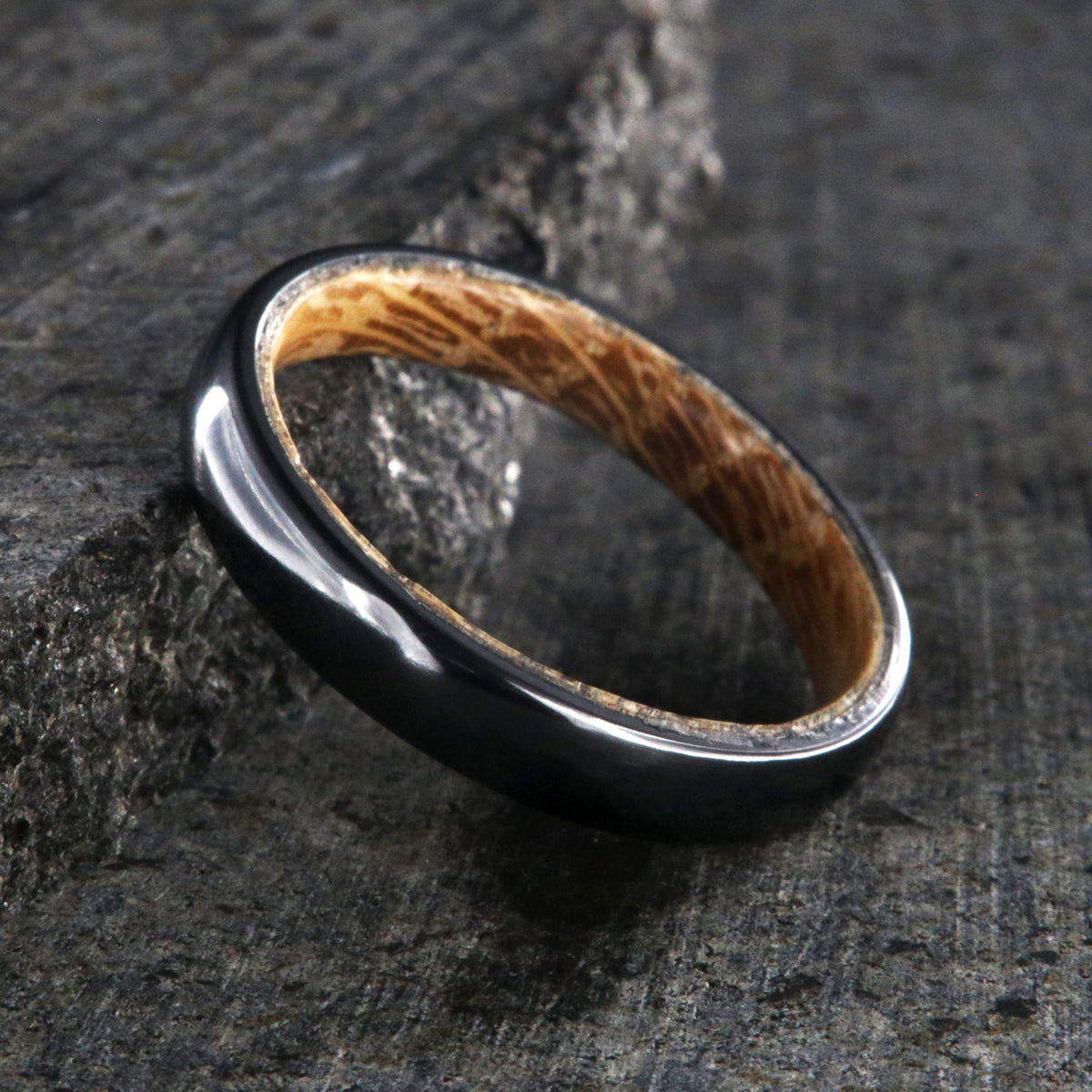 4mm wide black titanium wedding band with a rounded profile, polish finish, and whiskey barrel sleeve